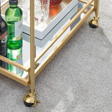 Carrito de bar de metal dorado con repisas de vidrio espejado