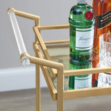 Carrito de bar de metal dorado con repisas de vidrio espejado